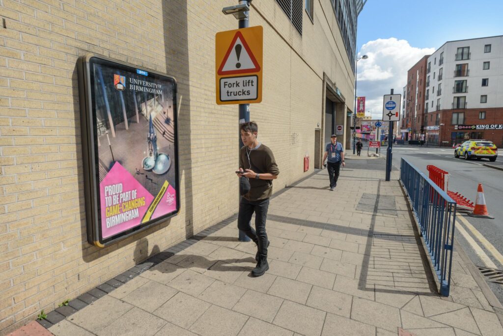 Digital screen advertising the Commonwealth Games fixed to a wall in central Birmingham